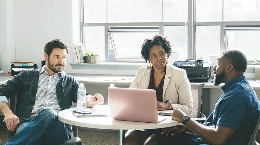 Colleagues looking at businessman